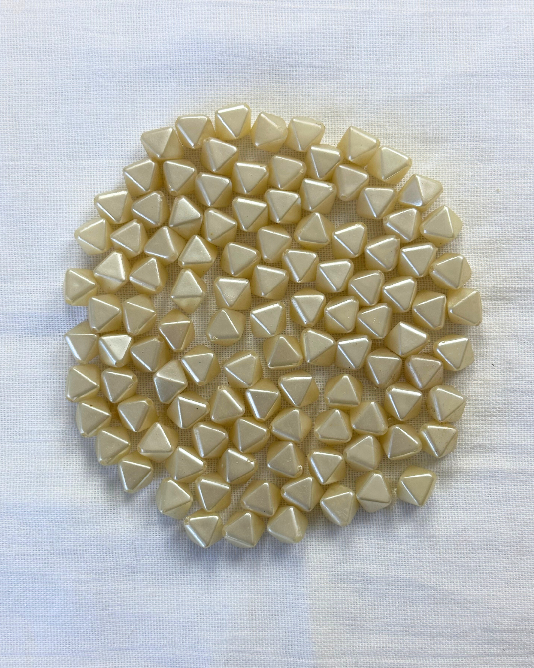 1980’s Cream Pearlescent Plastic Faceted Bicone beads