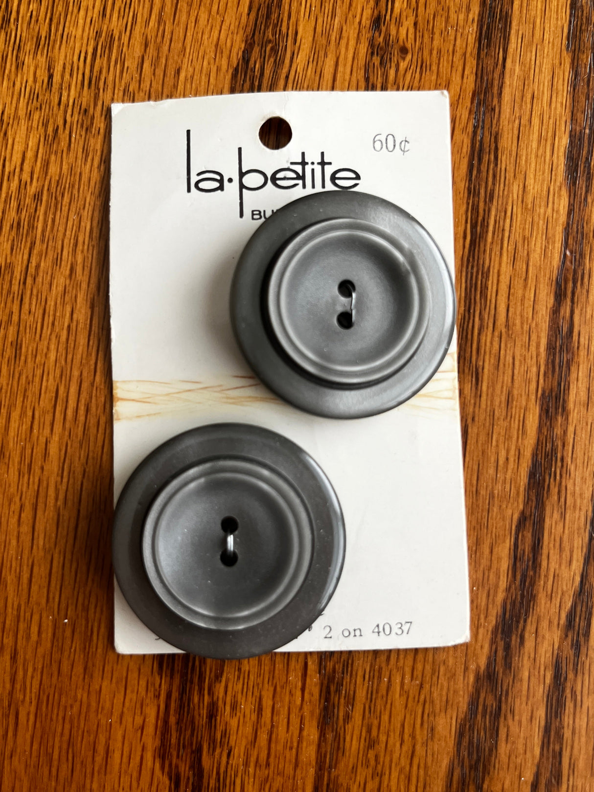 1980’s La Petite Dark Grey Plastic Carved Buttons - set of 2 - on card